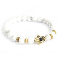 Goudkleurige armband Hamsa met witte steen
